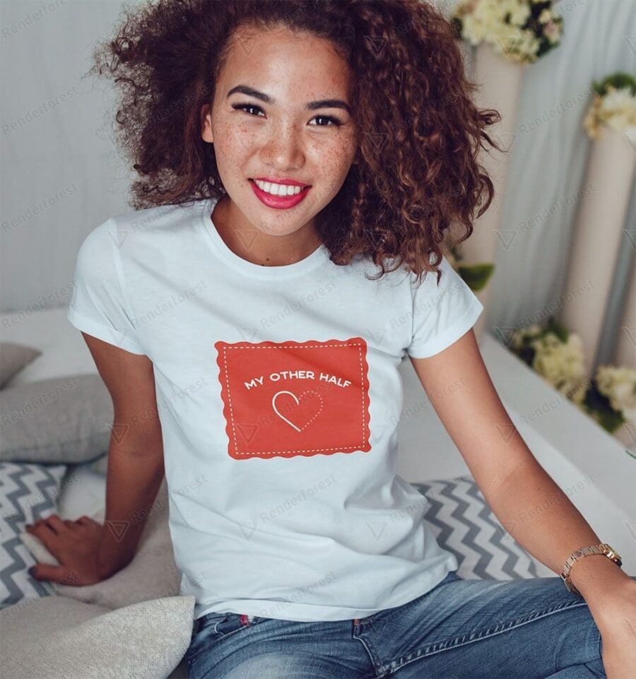 A woman wearing a My Other Half Love Unisex T-Shirt with a heart on it.