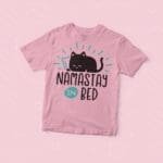 A Kid's "Namastay In Bed" Lazy Cat Jersey Tee with a lazy cat design that says "Namastay In Bed.