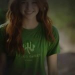 A young woman wearing a Bleed Green | St.Patricks Day | Unisex T-shirt showing her love for the color green.