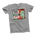A grey t-shirt with an image of a woman wearing a St. Patricks Day Red Hair Green Roots Tee.