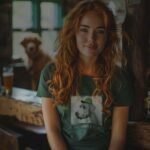 A woman wearing a Lucky Irish green t-shirt with a Wolfhound dog on it.