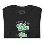 A black t-shirt that says "I Put The She in Shenanigans" Unisex t-shirt.