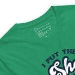 A green I Put The She in Shenanigans Unisex t-shirt with the word "sheesh" printed on it.