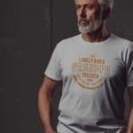 A man wearing The Lonely GRANDPA TRUCKER Unisex T-Shirt.
