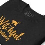 An Unisex Halloween black t-shirt with the phrase "witchful thinking".