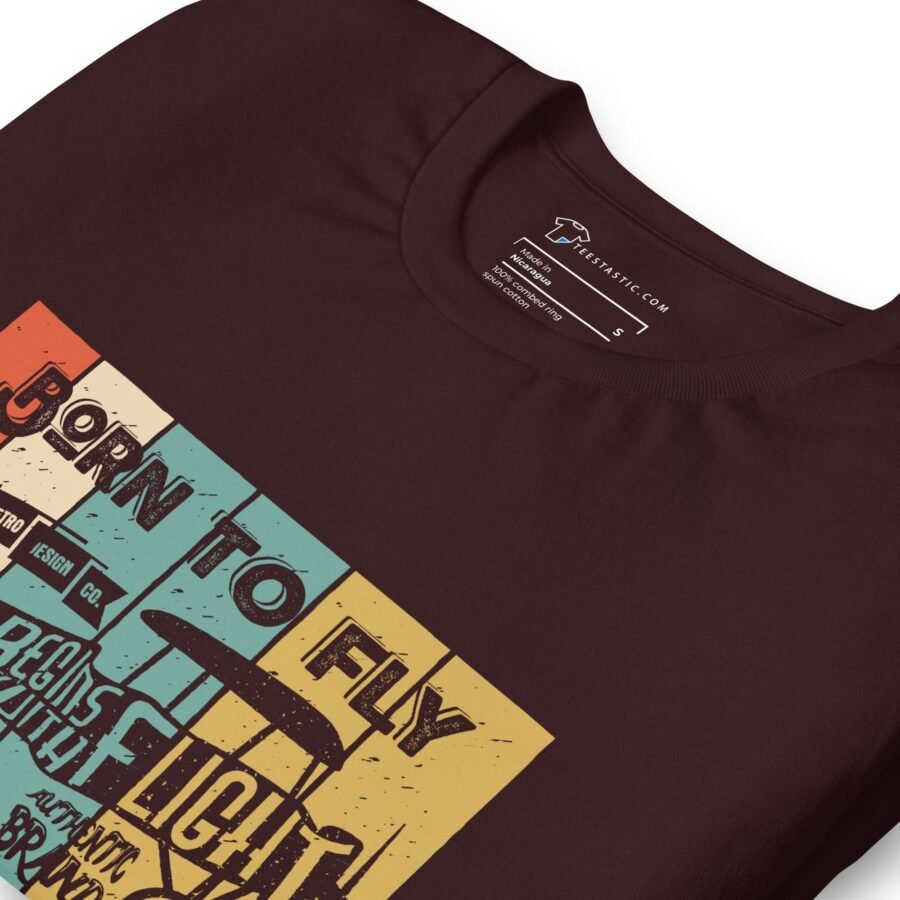 A brown t-shirt with an image of a plane flying in the sky, "Born To Fly | Unisex t-shirt | Aviation Enthusiasts" design.