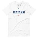 A white unisex heavy cotton tee with the word Nikki Haley | Elections 2024 | on it.