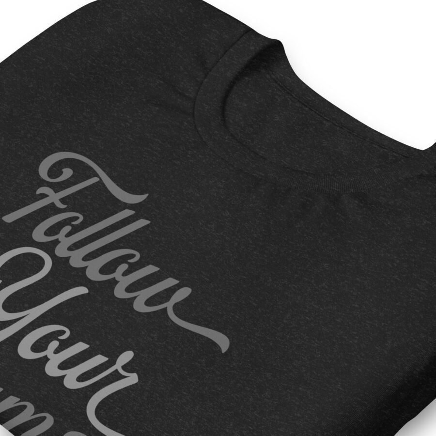 Unisex black Follow Your Dreams T-shirt printed with the phrase "Follow Your Dreams" on it.