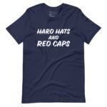 The "Hard Hats And Red Caps | Elections 2024 | Unisex t-shirt" is a navy blue, unisex t-shirt featuring the bold text "HARD HATS AND RED CAPS" in white, capital letters on the front, perfect for showing your spirit as Elections 2024 approaches.