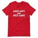 A vibrant unisex t-shirt in red, featuring bold white text that reads "HARD HATS AND RED CAPS" on the front—an ideal choice for showing your support in Elections 2024.