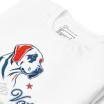 A white unisex t-shirt featuring a dog's face, a red star, and "Paws to Vote" text, labeled "PetsTastic" with size information. Ideal for the Elections 2024 season!