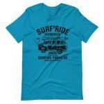 The Surf & Ride | Surfing Paradise Unisex Heavy Cotton Tee is a blue, high-quality shirt featuring a black graphic of a vintage van with surfboards on the roof. It showcases the text "SURF RIDE," "ENJOY THE RIDE," and "SURFING PARADISE," capturing the essence of the surfing lifestyle. Ideal for surfing enthusiasts who want to embrace the Surf & Ride way of life.