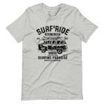 The "Surf & Ride | Surfing Paradise" Unisex Heavy Cotton Tee features a vintage Volkswagen van graphic along with the text "Surf & Ride," "Enjoy the Ride," and "Surfing Paradise." Adorned with mock addresses and fun surfing details, this T-shirt is perfect for any surf enthusiast.