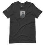 A unisex T-shirt in charcoal gray, featuring a graphic of a pioneer aviator with goggles and a helmet on the front, inspired by St. Louise Aircraft. The product is named "Pioneer Aviator | St. Louise Aircraft.