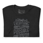 Unisex t-shirt in black featuring decorative white text that says, "Everything is possible for one who believes.